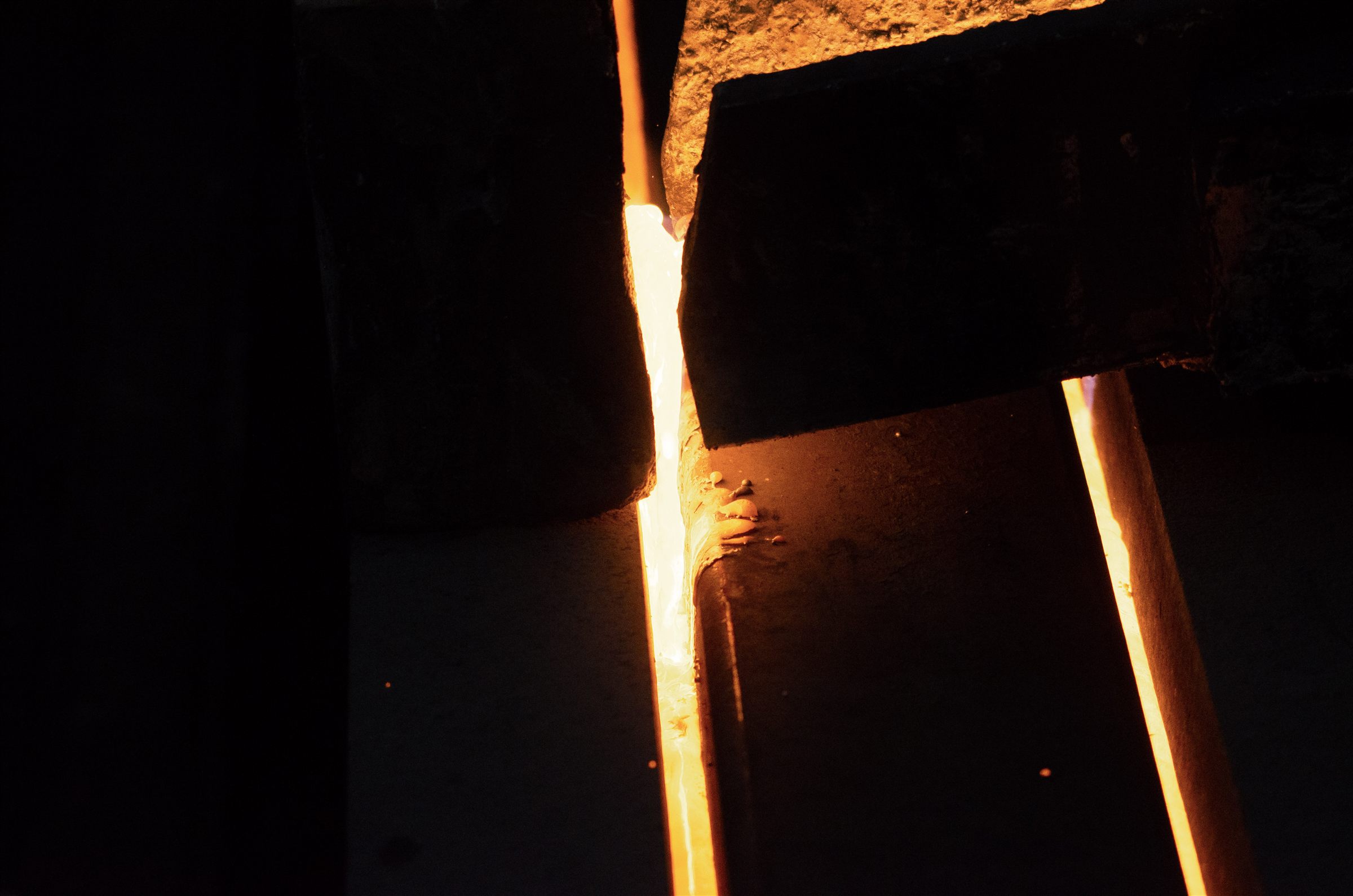 Furnace tooling illuminated by molten metal moving through a narrow channel