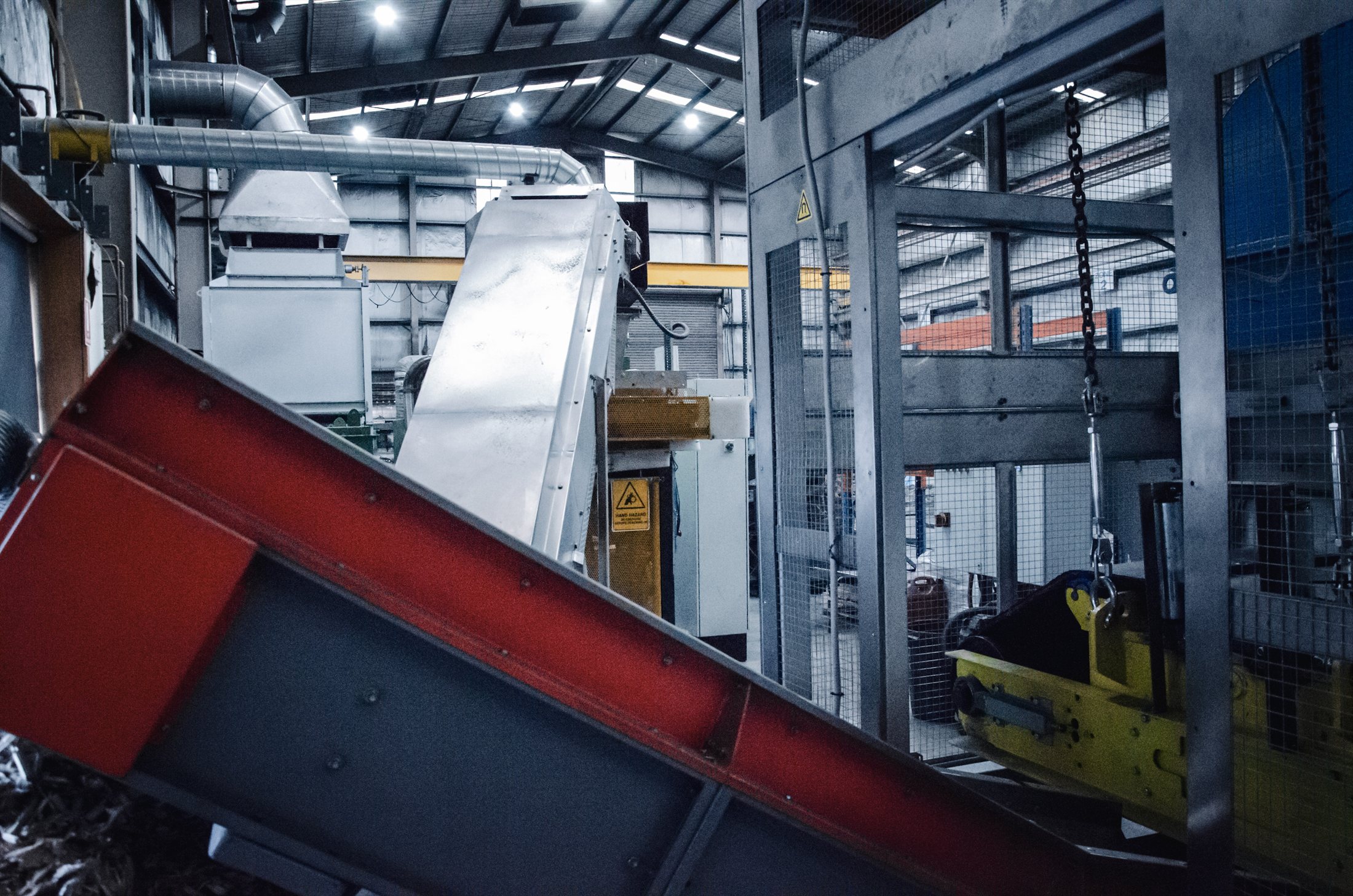 Conveyor and guarded processing line inside the biochar production facility