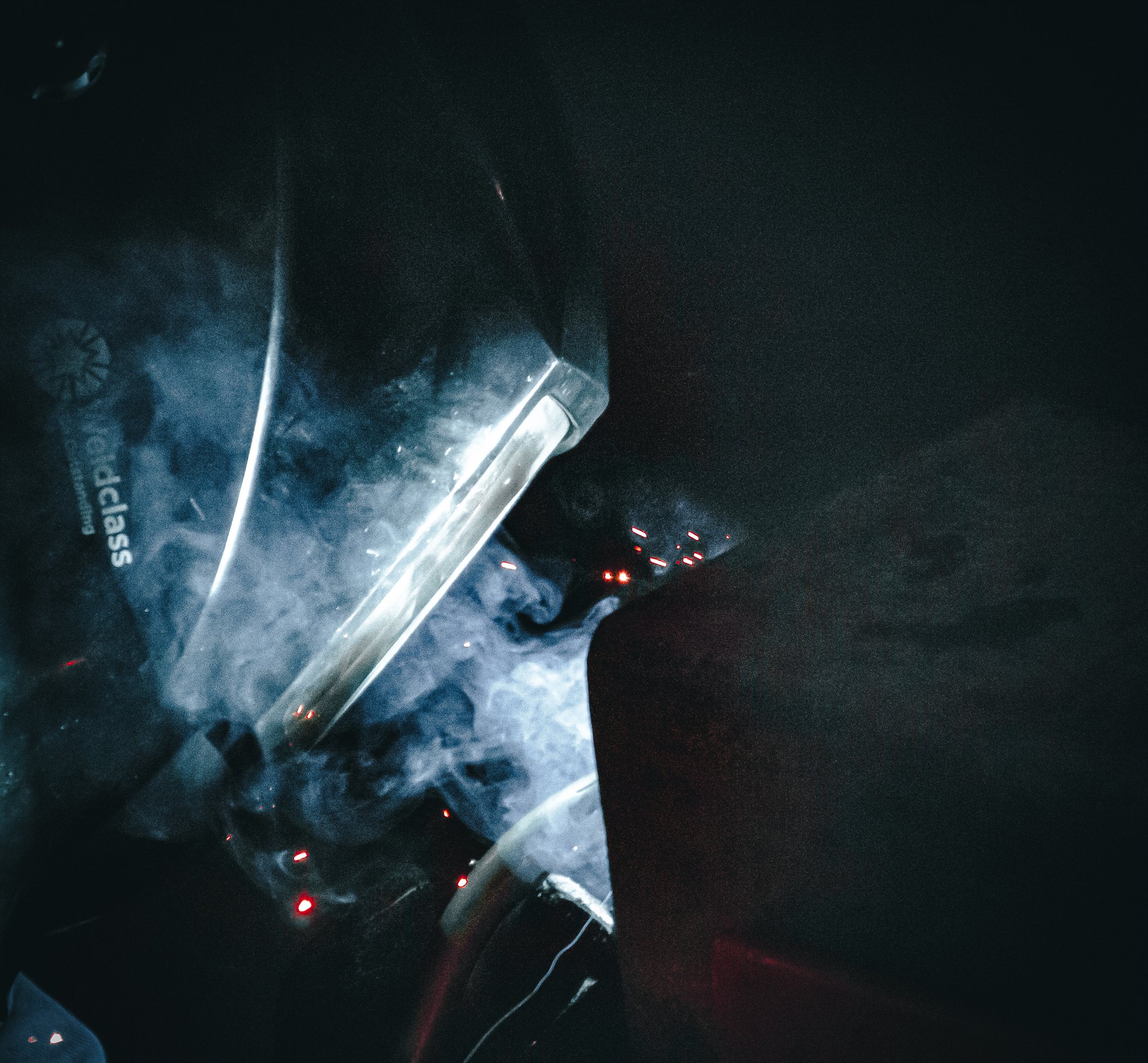 Sparks and smoke during controlled metalwork inside the workshop