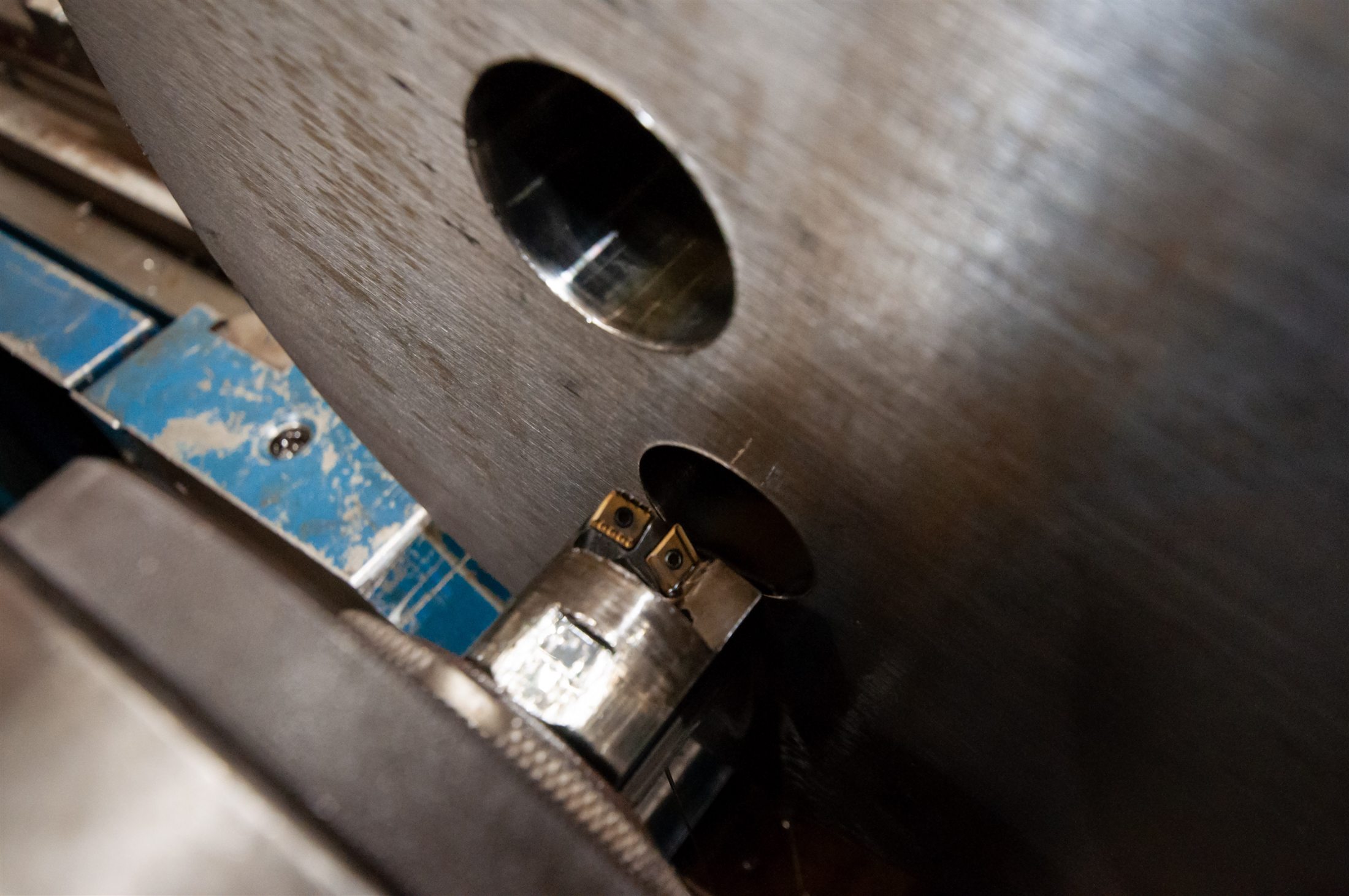 Close-up of an ejector head cutting inside a large machined component